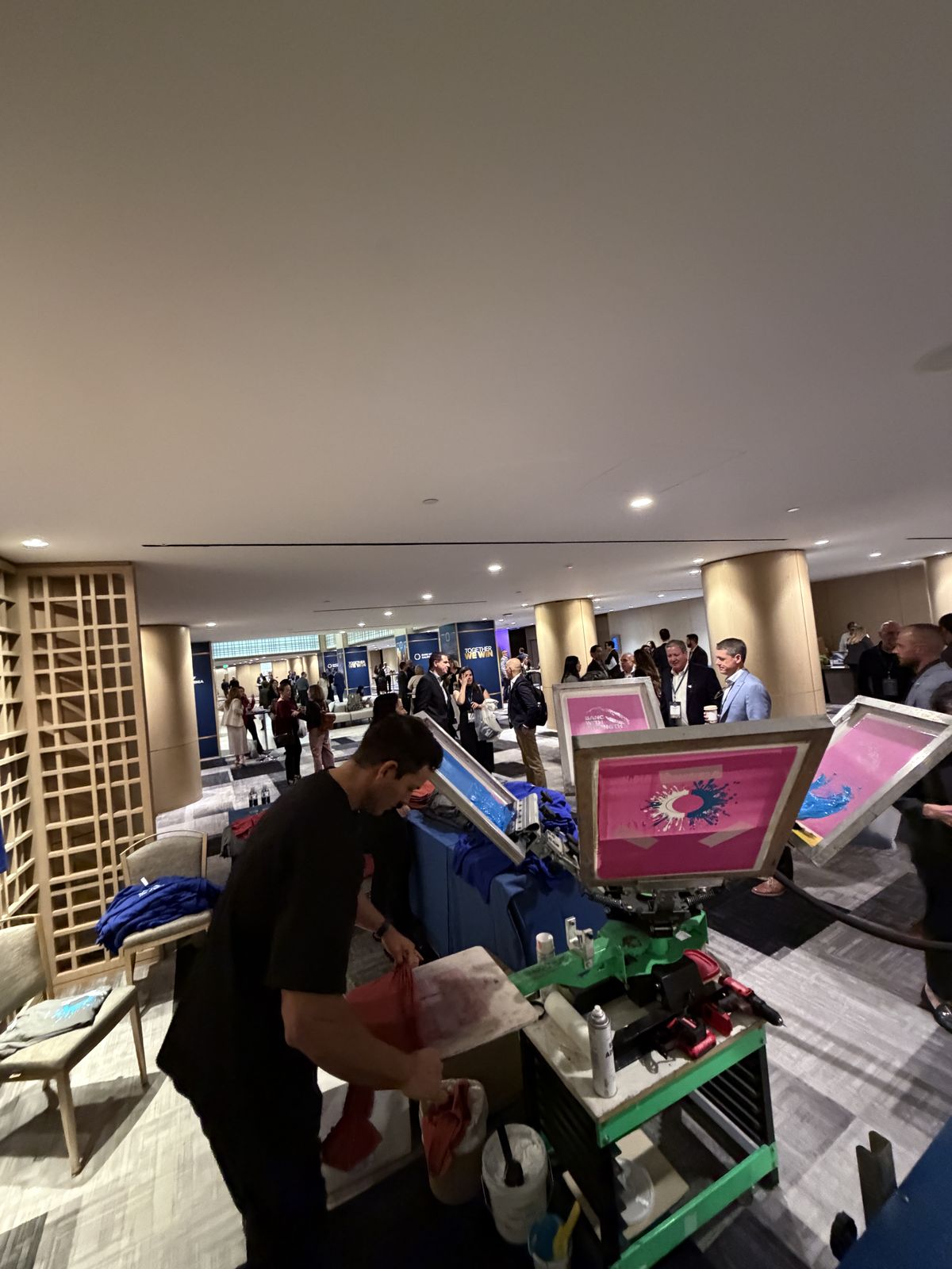 Live personalization station set up in a hotel ballroom foyer during a corporate reception